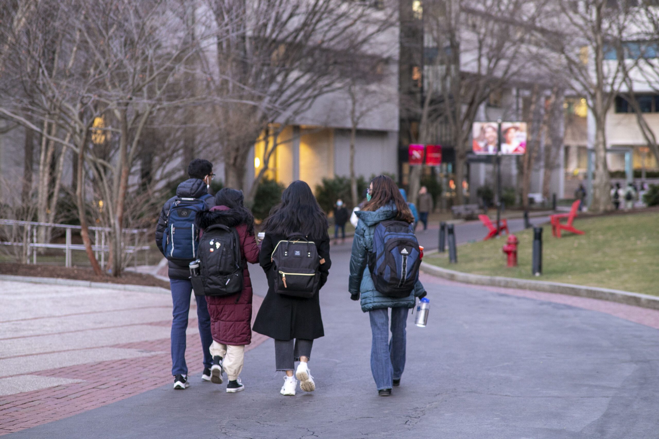 a group of students walking with backpacks on campus