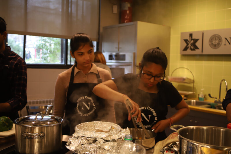 two women cooking in a kitchen