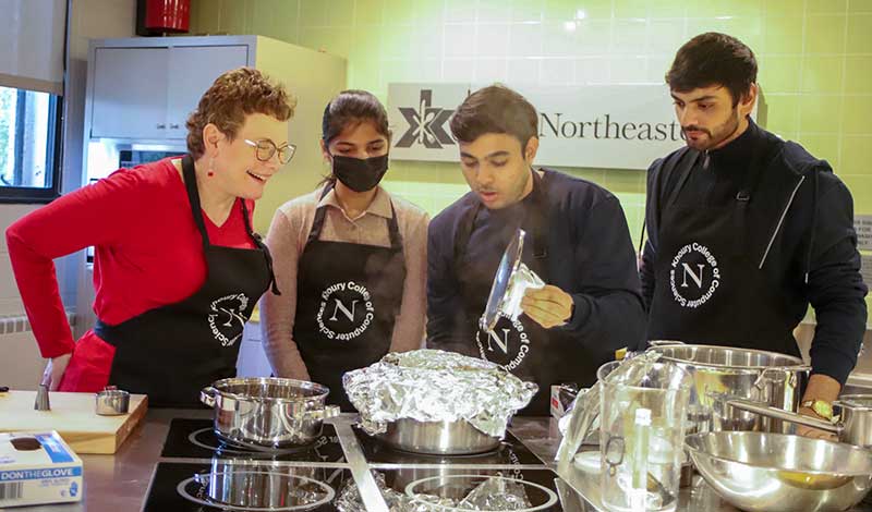 Dean Beth Mynatt cooks with a student team during the Khoury Cooks event.