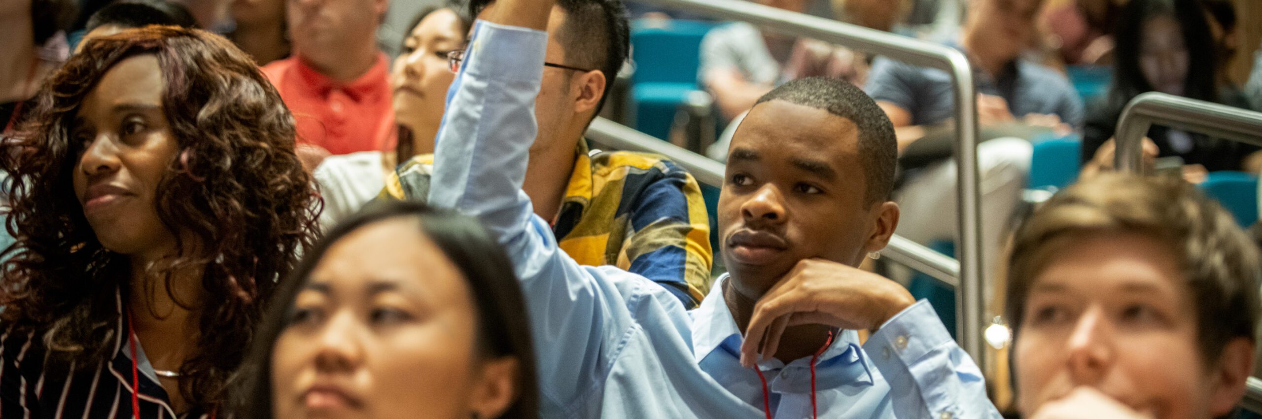 A student raises his hand during a lecture