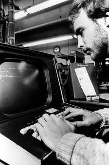 A student looks at a computer in the 1980s