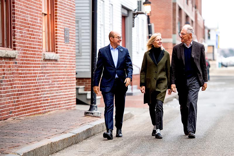 Joseph Aoun walks with the Roux family in Portland, ME