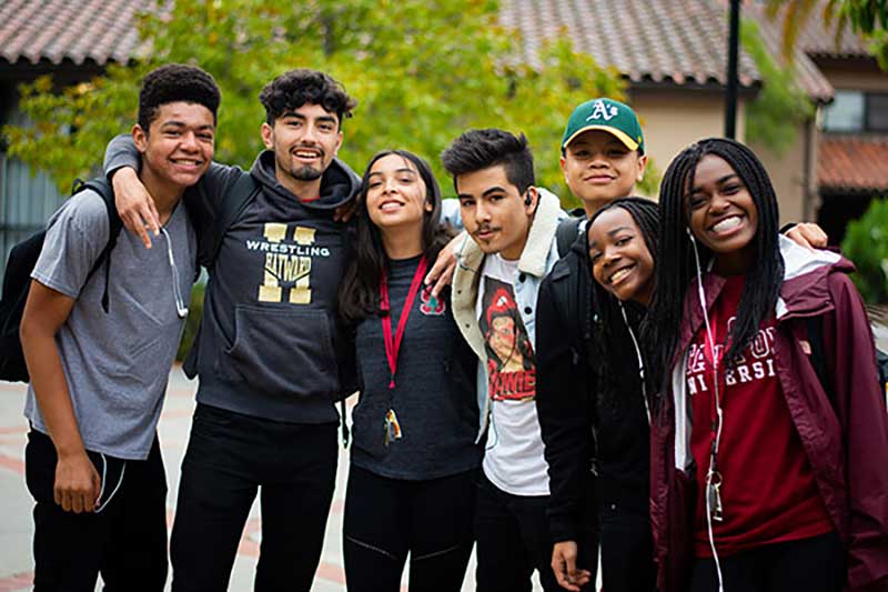 A group of students smiles