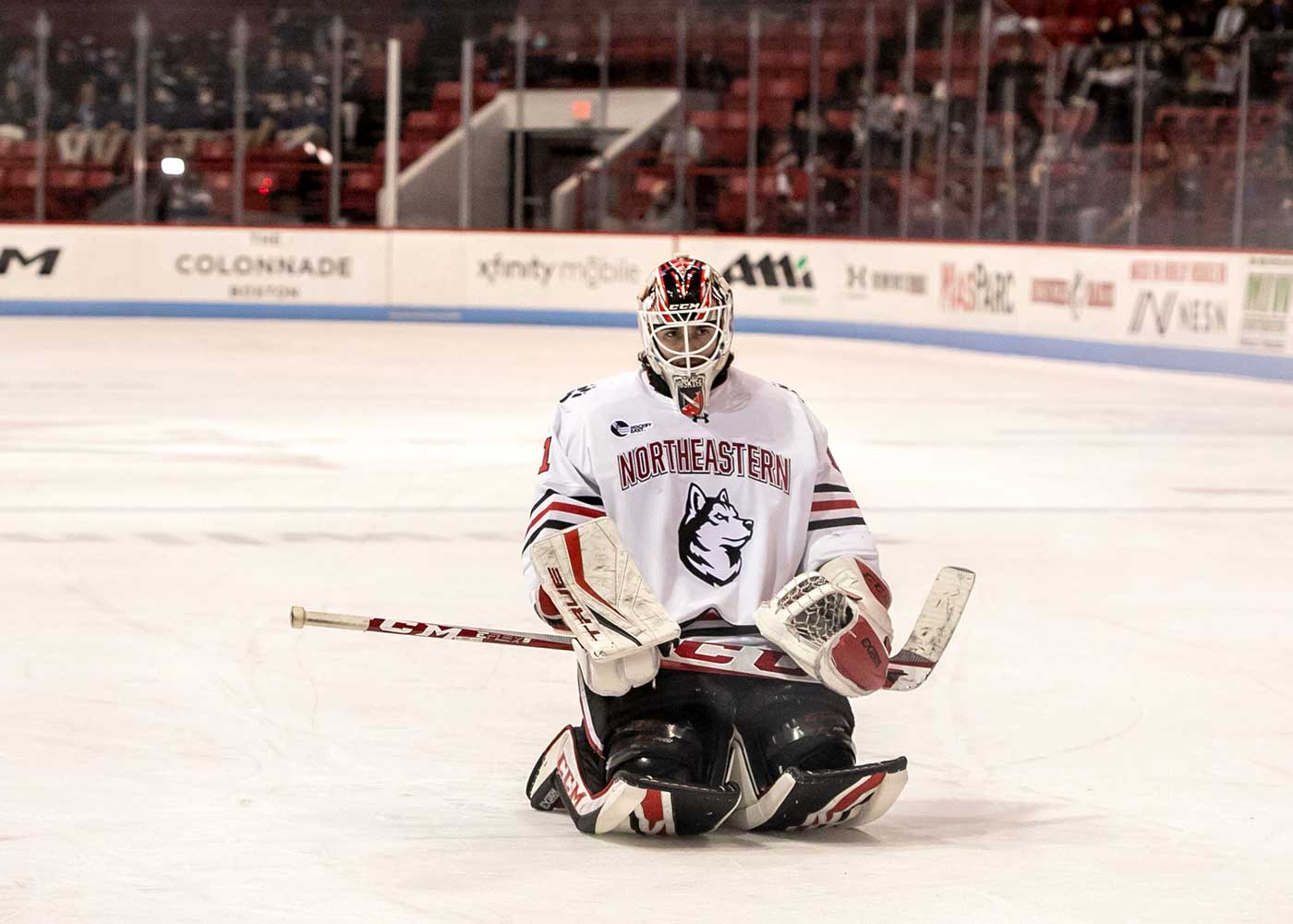 Devon Levi kneels on the ice