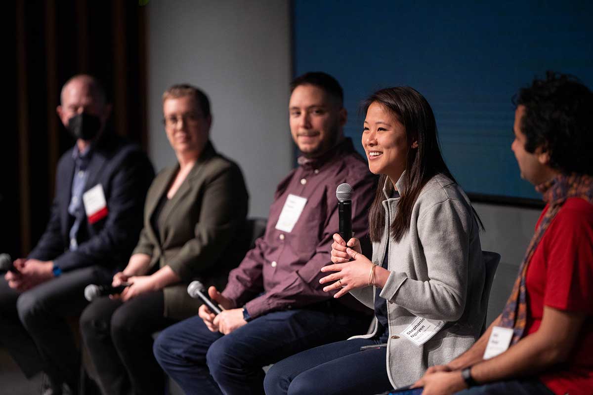 Members of the Cybersecurity and Privacy Research for Real-World Impact panel speak on stage