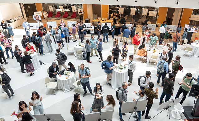 http://At%20the%20Khoury%2040th%20anniversary%20culmination%20celebration,%20guests%20mingle%20and%20discuss%20research%20posters%20in%20the%20ISEC%20atrium
