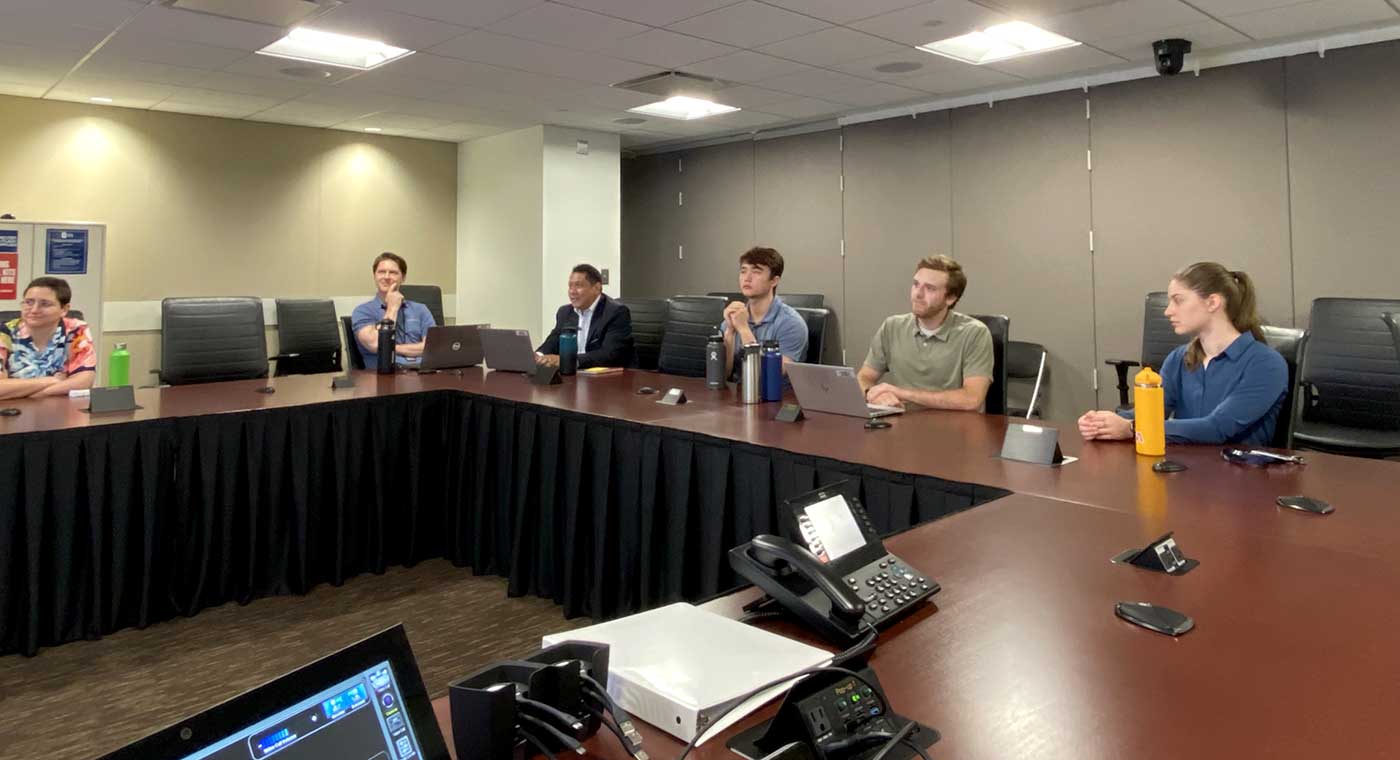 Owen Seltzer and a team from NASA sit in a conference room. Photo credit: NASA SCaN on X