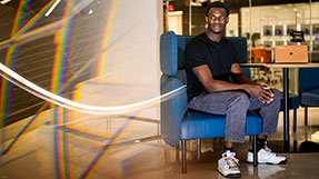 David Alade, who studies computer science, works on his business venture, Bibite, in the EXP building on Northeastern’s Boston campus. Photos by Matthew Modoono/Northeastern University