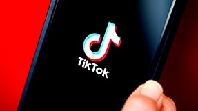 a phone showing TikTok's logo on its screen