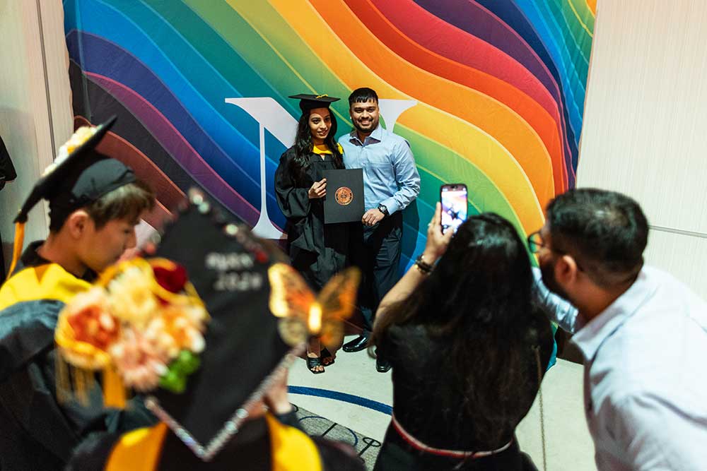 This graduate and her guest take a moment for a colorful photo-op.
