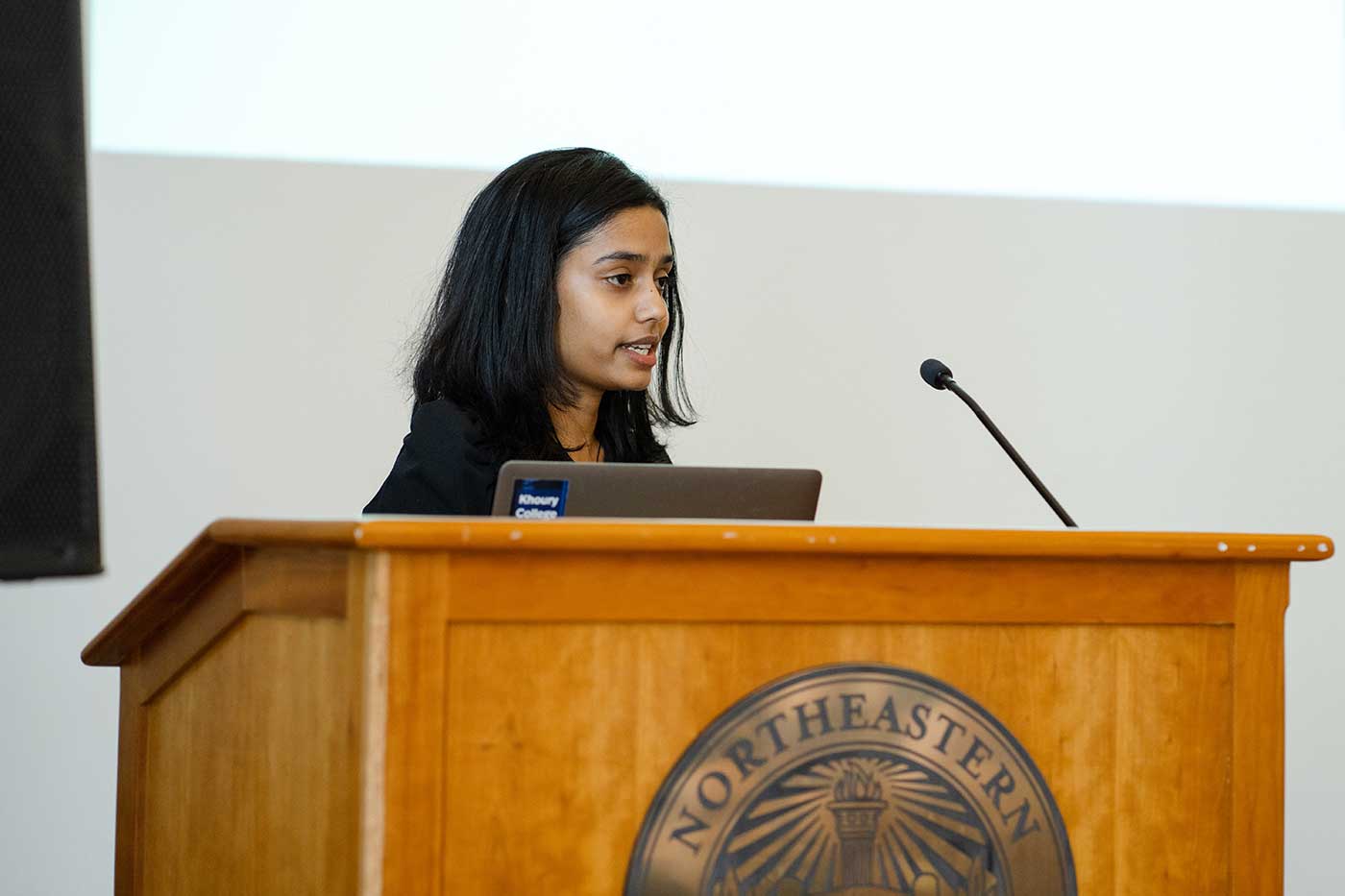 Vidya Ganesh presents her project standing behind a podium