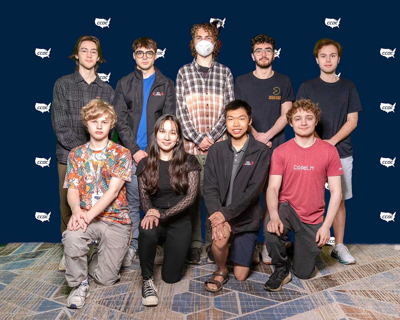 Nine members of Northeastern University’s Collegiate Cyber Defense Competition team pose for a photo at the competition.