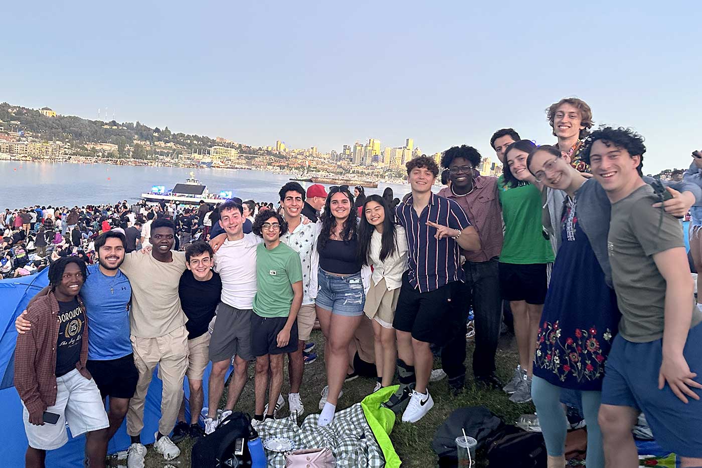 Khoury interns pose for a photo on a hill above a body of water