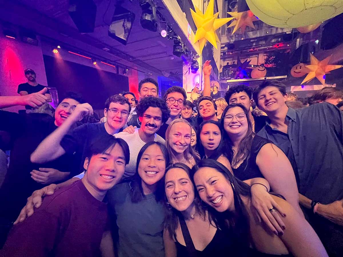 16 Khoury students pose for a photo at a club in Sydney