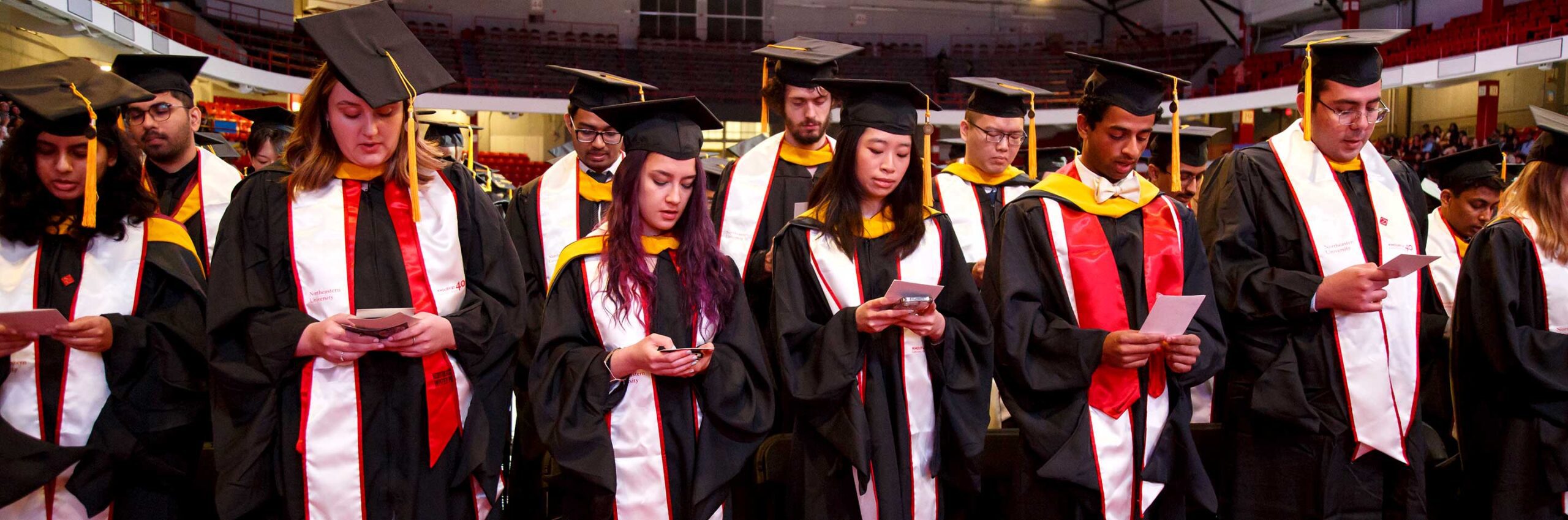 Khoury graduates read the oath while standing at the 2024 Khoury graduation celebration